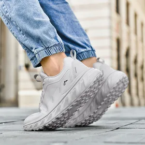 Breathable wide-toe platform sneakers in light grey worn with jeans on a street
