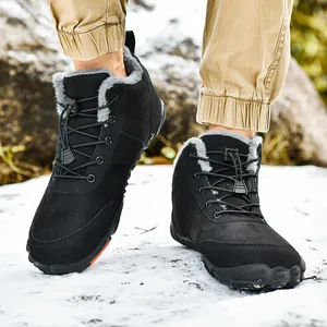 Black high-top winter snow boots with warm fleece lining worn on snowy outdoor ground