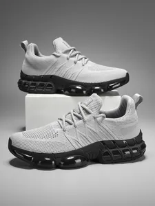 Detail of grey mesh breathable upper and black technical sole on casual running sneakers