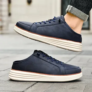 Men's navy blue faux leather slip-on loafers with thick cream sole and lace decoration