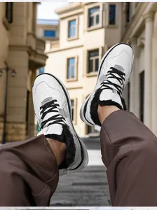 Close-up of men high-top winter sneakers with warm black plush lining and white leather