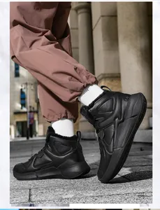 Detail view of high-top winter sneakers with thick black fleece lining and durable leather