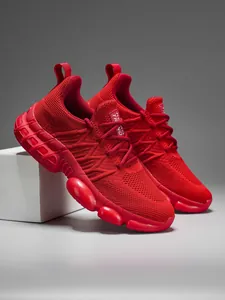 Macro detail of red breathable mesh upper and tech rubber bubble sole with Retro Trend label