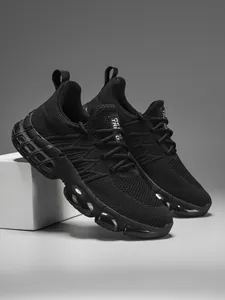 Detail of black running shoes featuring breathable mesh and transparent cushioned sole