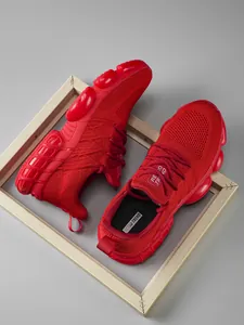 Detail of red mesh running shoes featuring thick soles and Retro Trend insoles