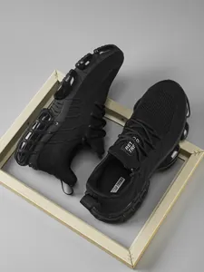 Close-up of black breathable mesh running shoes with Retro Trend logo and textured sole