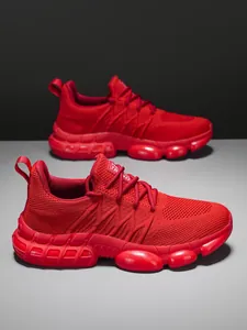 Detail of red breathable knit running shoes with thick bubble cushioning and Trend logo