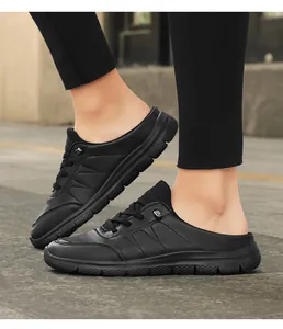 Close-up of black litchi pattern leather mule sneakers with non-slip rubber soles