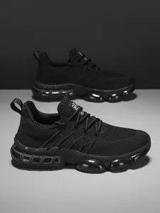Detail of black men's running shoes featuring knit mesh upper and clear air cushion sole