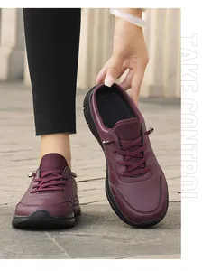 Deep burgundy leather mule with purple laces and thick black rubber sole on stone road