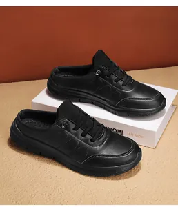 Detailed view of black faux leather mule shoes with textured finish and non-slip sole