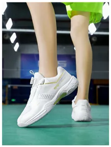Detail of indoor badminton shoes featuring rotary lacing system and gold accents