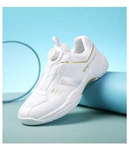 Macro shot of white badminton shoe with gold trim and convenient knob lacing system