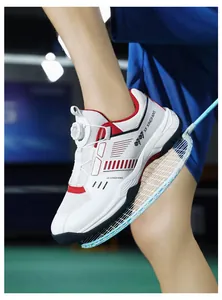 Detail of professional badminton shoes with dial lacing system on indoor court