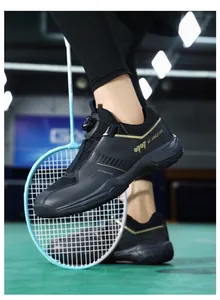 Detail view of indoor badminton shoes featuring black mesh and knob lacing system on court