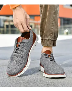 Close-up of gray knit men sneakers showing breathable fabric and brown leather accents