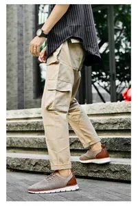 Detail view of khaki cargo pants with large side pockets for trendy outdoor casual wear