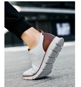 Detail of white knit sneaker featuring brown leather brogue heel and thick anti-slip sole