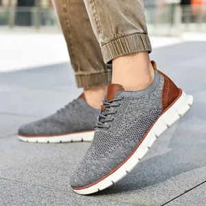 Men's lightweight grey fly-knit casual sneakers with brown leather accents and white soles