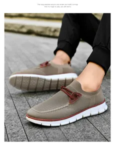 Detail of khaki breathable mesh slip-on shoe with leather stitching on thick rubber sole