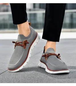 Close-up of gray breathable knit slip-on sneakers with brown leather accents and white sole
