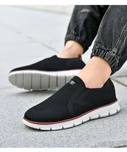 Gros plan sur des baskets noires en tricot respirant avec semelles blanches légères