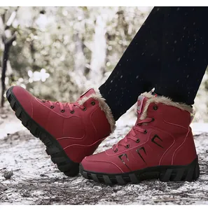 Detail of red winter snow boots with warm beige faux fur lining and anti-slip sole