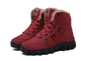 Detail view of red winter boots featuring thick faux fur lining and anti-slip rubber soles