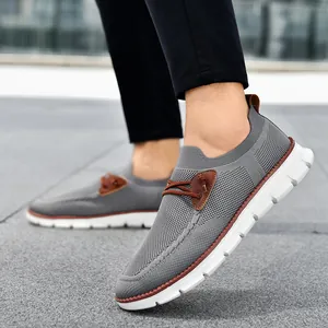 Men's grey breathable fly-knit casual shoes with brown leather accents and white soles
