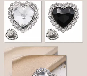 Detailed view of heart-shaped crystal buttons with rhinestones in black and clear colors