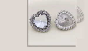 Makroaufnahme von Herz-Strass-Knopf mit silbernem Metallsockel und Nähschlaufe