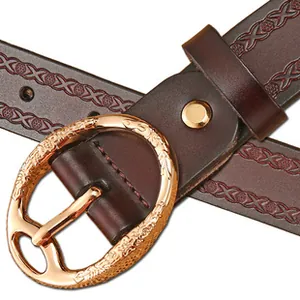 Detail of dark brown leather belt with vintage gold embossed buckle and floral pattern