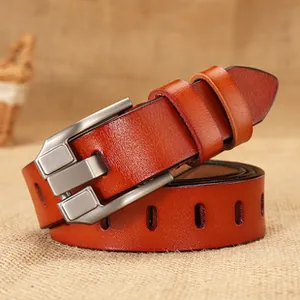 Detailed macro view of the cognac leather belt with matte silver alloy pin buckle