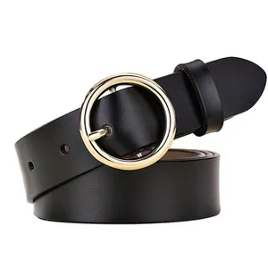 Close-up of a women's slim black leather belt featuring a round polished gold metal buckle