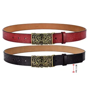 Detail of red and black leather belts featuring floral embossing and gold hollow buckles