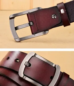 Detail of dark burgundy leather belt with gunmetal brushed buckle and precise stitching