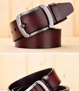 Detailed macro view of deep brown genuine leather belt with brushed metal buckle