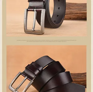 Detail of vintage men's brown leather belt with brushed alloy pin buckle on natural background