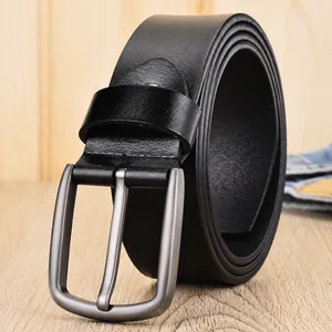 Men's genuine black leather belt with silver matte pin buckle on wooden background