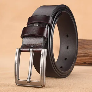 Men's retro dark brown leather belt with silver brushed metal buckle on natural sand background