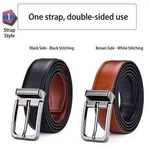 Detail of reversible men's leather belt showing black and brown sides with metal buckle
