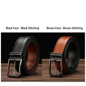 Detail of reversible leather belt in black and brown with neat stitching on wooden surface