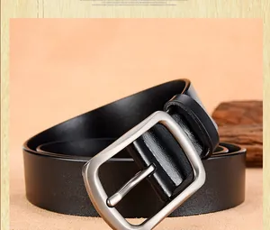 Close-up of men's black leather belt featuring a silver brushed metal pin buckle