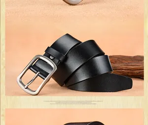 Detailed view of black leather belt with brushed silver metal buckle and grain texture