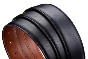 Macro detail of black pebble leather belt with brown back and white stitching