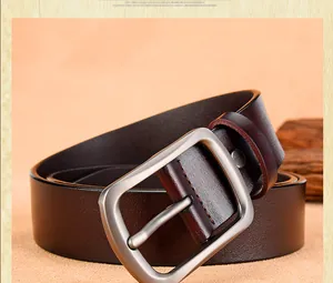 Macro shot of men's leather belt featuring a matte silver buckle and textured strap