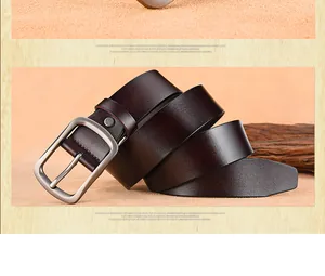 Detailed close-up of dark reddish-brown genuine leather belt with metallic silver pin buckle