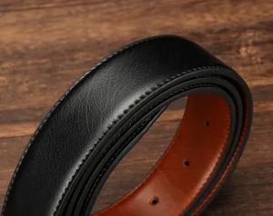 Close-up of black lychee grain leather belt with orange lining and precision stitching