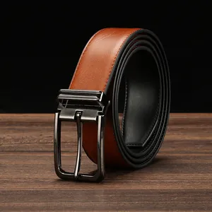 Detailed close-up of a brown leather belt with a gunmetal pin buckle on a wooden surface