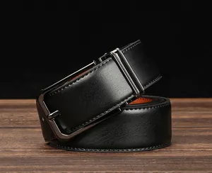 Close-up of black leather business belt with a gunmetal buckle on dark wood table